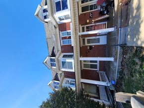Red Lion apartment for rent - A tall building with a red brick facade and white trim around the windows.
