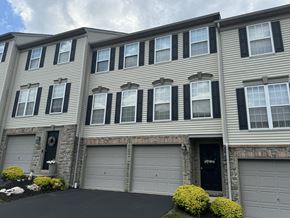 York apartment for rent - A grey house with black shutters and a black garage door.