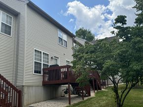 York apartment for rent - A house with a deck and a tree in front.