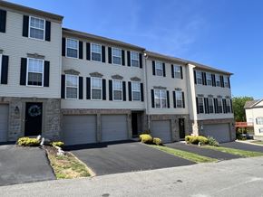 York apartment for rent - A building with a black door and windows with shutters.