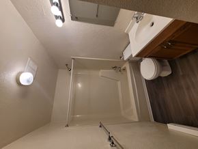 Mount Wolf apartment for rent - A white bathroom with a toilet, sink, and shower.