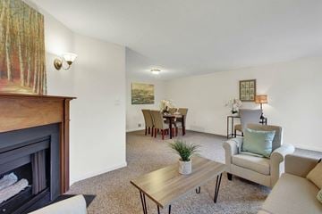 Wrightsville apartment for rent - A living room with a fireplace and a painting on the wall.