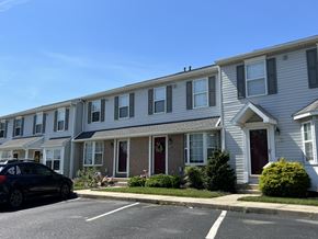 Red Lion apartment for rent - A black car is parked on the street in front of a row of houses.
