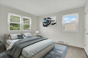 Dover apartment for rent - A bedroom with a large bed and a painting on the wall.