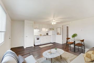 Dover apartment for rent - A living room with a white couch and a coffee table.