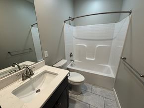 Red Lion apartment for rent - A white toilet is in a bathroom with a white shower curtain.