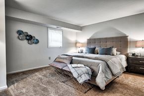 Ephrata apartment for rent - A bedroom with a large bed and a decorative wall piece.