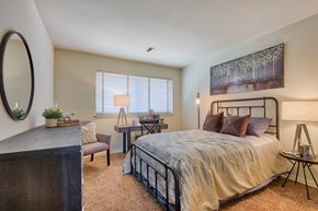 York apartment for rent - A bedroom with a bed, chair, and a table.