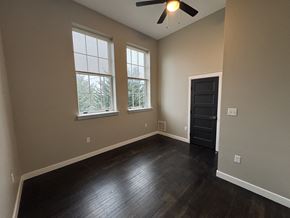 Red Lion apartment for rent - A room with a ceiling fan and two windows.
