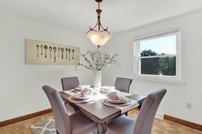 Wrightsville apartment for rent - A dining room with a table set for four and a chandelier hanging from the ceiling.