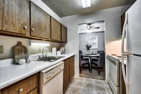 Ephrata apartment for rent - A kitchen with wooden cabinets and a white fridge.