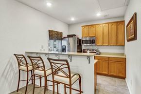 Virginia Beach apartment for rent - A kitchen with wooden cabinets and a white countertop.