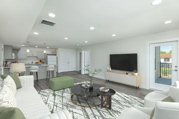 York apartment for rent - A modern living room with a white sofa and a black coffee table.