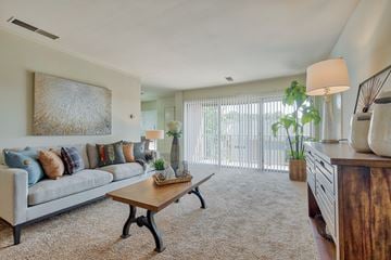 York apartment for rent - A living room with a grey couch, a wooden coffee table, and a painting on the wall.