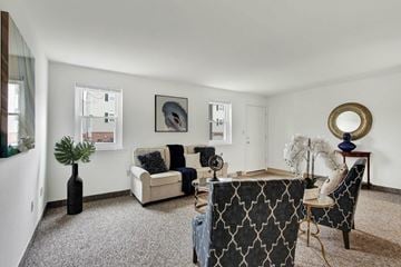 York apartment for rent - A living room with a grey carpet and a white couch.
