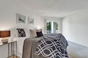 Richmond apartment for rent - A bedroom with a large bed and two pictures on the wall.