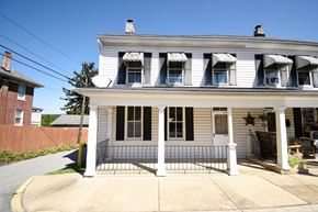 Wrightsville apartment for rent - A white house with black shutters and a black gate.