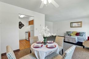 Manchester apartment for rent - A dining room with a table set for two and chairs around it.