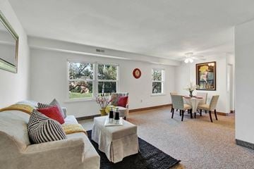 Manchester apartment for rent - A living room with a couch, a coffee table, and a dining table set up.