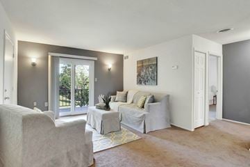 Harrisburg apartment for rent - A living room with a couch, chair, and a painting on the wall.