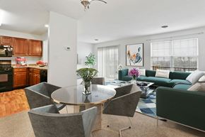 Harrisburg apartment for rent - A modern dining room with a glass table and grey chairs.