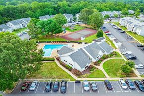 Fredericksburg apartment for rent - A bird's eye view of a residential area with houses, cars, and a swimming pool.