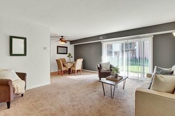 Harrisburg apartment for rent - A living room with a brown chair and a brown couch.