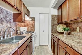 Harrisburg apartment for rent - A kitchen with brown cabinets and a white door.