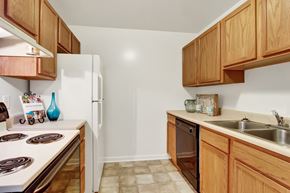 Hagerstown apartment for rent - A kitchen with wooden cabinets and a white stove top.