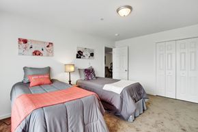 Hagerstown apartment for rent - A bedroom with two beds and a painting on the wall.