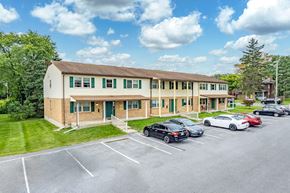Hagerstown apartment for rent - A parking lot in front of a building with cars parked.