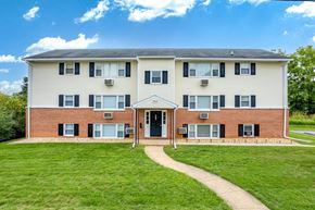 Hagerstown apartment for rent - A two-story building with a brick facade and a white roof.