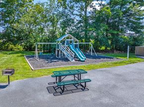 Ephrata apartment for rent - A playground with a green slide and picnic table.