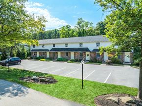 Dallastown apartment for rent - A parking lot in front of a building with a car parked in the lot.