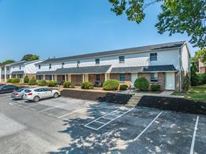 Dallastown apartment for rent - A parking lot in front of a building with cars parked.