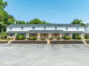 Dallastown apartment for rent - A building with a parking lot in front of it.