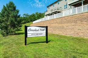 Harrisburg apartment for rent - A sign for Crooked Hill Owned by Ownvoices stands in a grassy area.