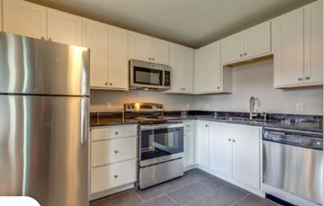 Nashville apartment for rent - A modern kitchen with stainless steel appliances and white cabinets.