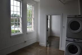 Nashville apartment for rent - A laundry room with a washer and dryer stacked on top of each other.