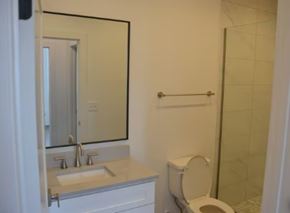 Nashville apartment for rent - A white toilet sits next to a sink in a bathroom.