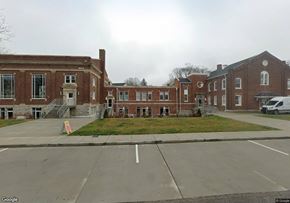 Nashville apartment for rent - A large brick building with a parking lot in front.