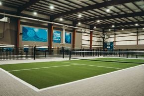 Biloxi apartment for rent - A tennis court inside a building with a sign that says "Home Court".