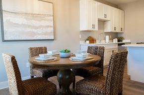 Biloxi apartment for rent - A dining room with a table set for two and a painting on the wall.