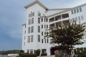 Biloxi apartment for rent - A white building with a balcony on the second floor.