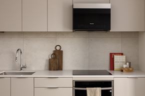 Vancouver apartment for rent - A kitchen with a white countertop and a black oven.