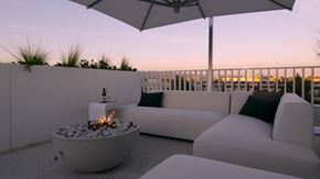 Vancouver apartment for rent - A patio with a fire pit and white furniture.