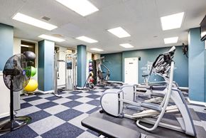 Seattle apartment for rent - A gym with a fan, weights, and exercise equipment.