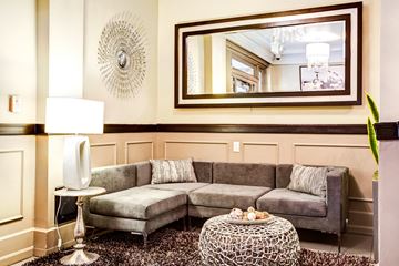 Seattle apartment for rent - A living room with a grey couch and a round table.