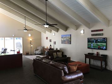 Englewood apartment for rent - A living room with a brown leather couch and a television.