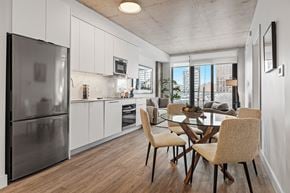 Ottawa apartment for rent - A modern kitchen with a glass table and chairs.